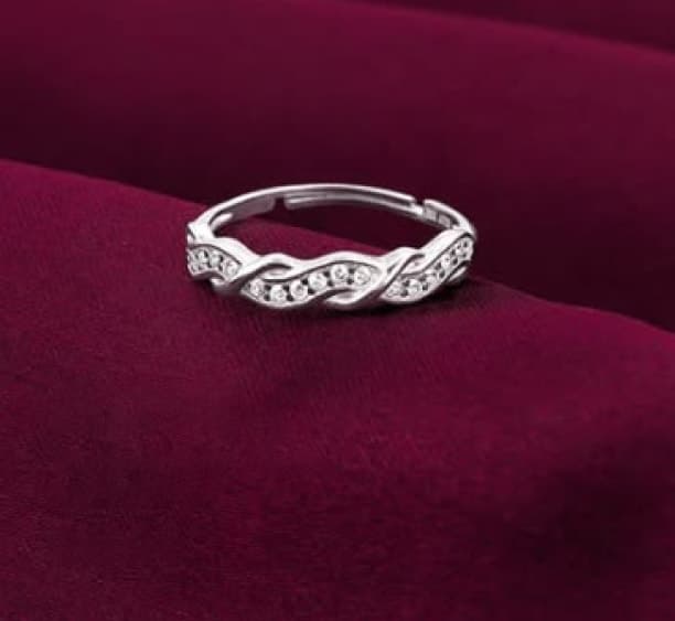 Silver ring set with stones on burgundy velvet
